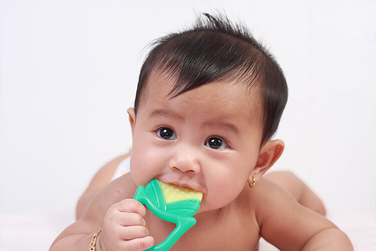 Baby chewing on teething toy